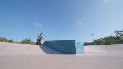 Young Man Rides BMX Bicycle and Jumps