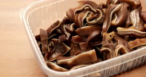 Close Up of Container of Cooked Pig Ears