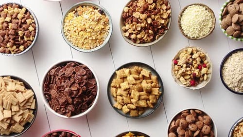 Assortment of Different Kinds Cereals Placed in Ceramic Bowls on Table