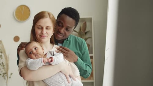 Happy Family with Infant in a Bright Home