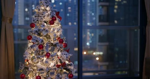 Festive Christmas Tree in City Apartment at Night