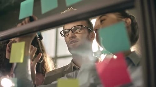 Team Brainstorms Ideas Using Sticky Notes