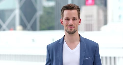 Smiling Man in Blazer Standing in City
