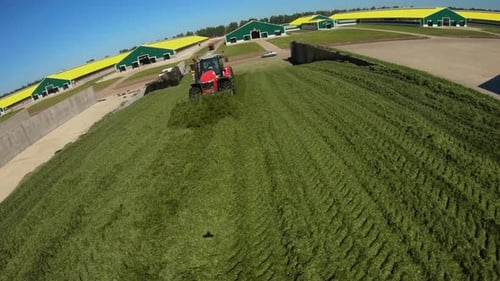 Hélicoptère volant autour de tracteurs dans un silo dans une ferme