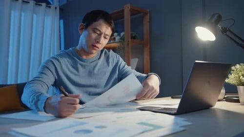 Man Working on Laptop Late at Night