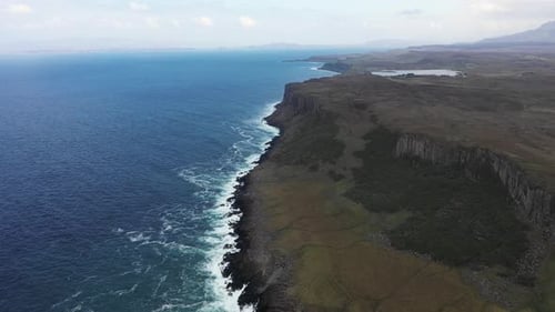 Aerial view of rocky coastline and waves