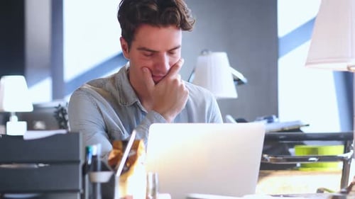 Creative Man Thinking and Working in His Office