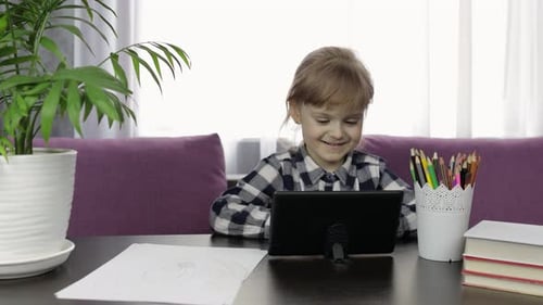 Child Using Tablet at Table Indoors