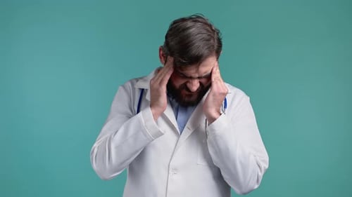 Doctor Man Having Headache Studio Portrait