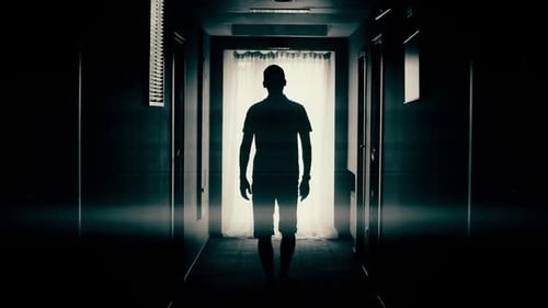 Man Walk Down a Corridor