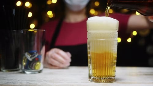 Bartender Pouring Beer in the Bar