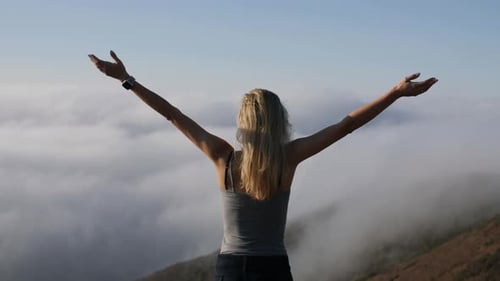 Woman Enjoying Mountain Views With Arms Raised