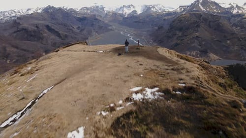 Man standing on top of mountain looking at the view