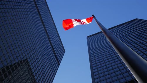 Canadian Flag Waving Between Skyscrapers
