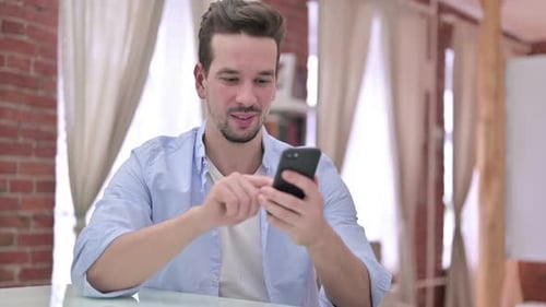 Man Using Smartphone, Smiling