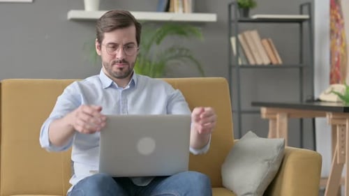 Young Man Closing Laptop Leaving Sofa