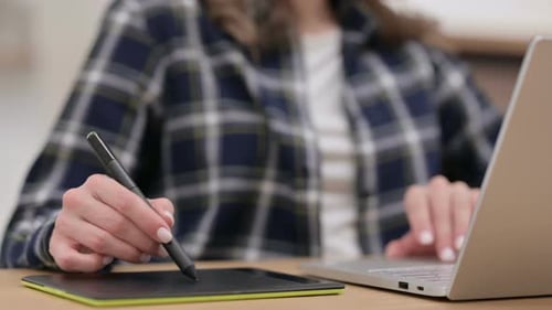 Female Hands Designing on Graphic Tablet with Stylus Close Up