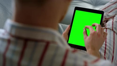 Person Scrolls on Tablet with Chroma Key