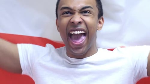 Man Cheering with Red and White Flag