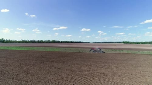 Aerial View Tractor Plows the Land, Processing the Field Before Sowing, Spring