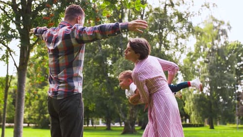 Happy Family Playing at Summer Park