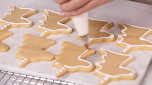 Step by step. Decorating unicorn shaped sugar cookies with royal icing for little girl birthday part