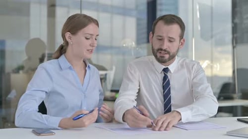 Business Colleagues Reviewing Data in Modern Office