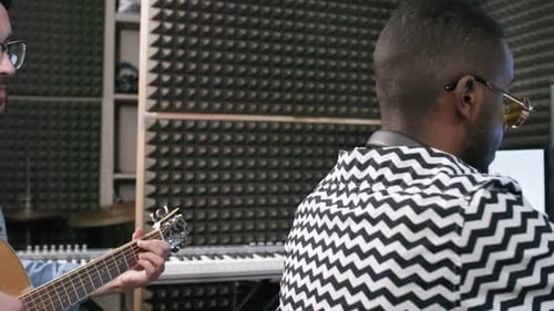 Sound Engineer and Musician Writing New Track