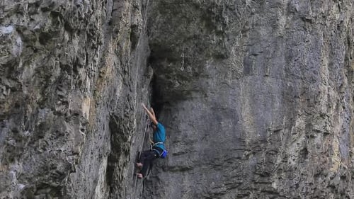 A man rock climbing up a mountain.