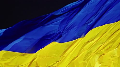 Ukraine Flag Waving in the Wind at Night