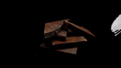 Milk Pouring onto Chocolate Pieces in Slow Motion