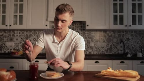 Young Adult Enjoying Breakfast in a Kitchen