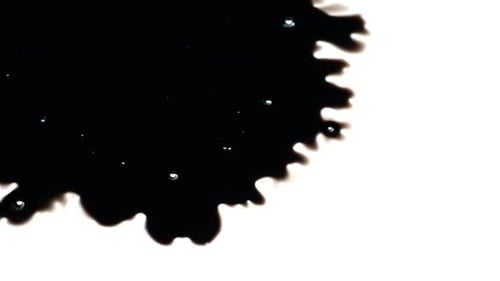 Black Ink Spreads on White Surface