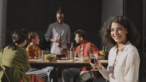 Friends Gathering for Meal, Woman Holding Wine