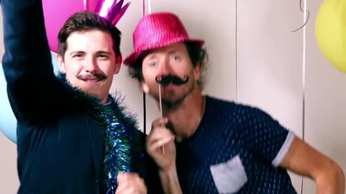Two men dancing in photo booth