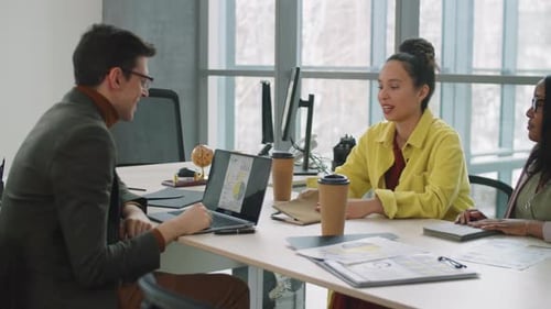 Colleagues Analyzing Data in Modern Office Space