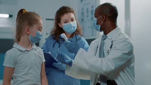 Physician and Nurse Measuring Temperature with Thermometer