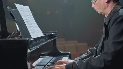 Adult Plays Piano in Concert Hall