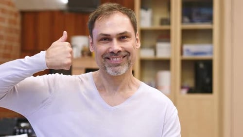 Thumbs Up By Middle Age Man Businessman in Office