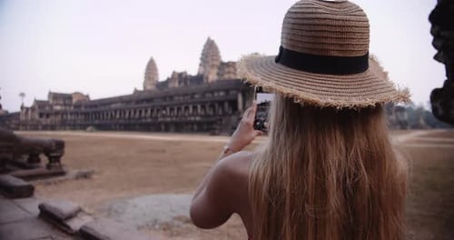 Blonde Person Capturing One of the Iconic Ruins in Cambodia