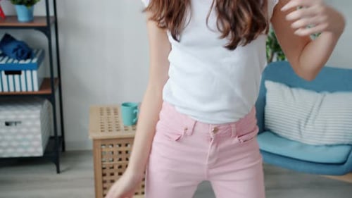 Teen Girl Dancing with Headphones in Living Room
