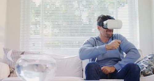 Man Using Virtual Reality Headset on Sofa