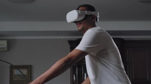 Man Enjoys Virtual Reality Gaming at Home