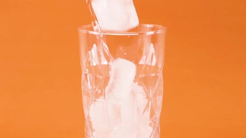 Ice Cubes Falling into Glass, Water Pouring