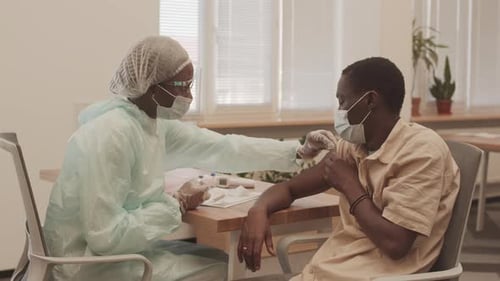 Healthcare Worker Giving an Injection to an Adult
