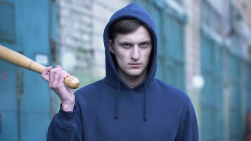 Man in Hoodie Holds Baseball Bat