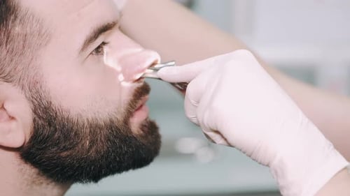 Man Receiving Nasal Medical Exam at the Doctor
