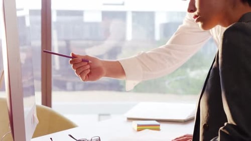 Team Working Together on Desktop Computer in Office