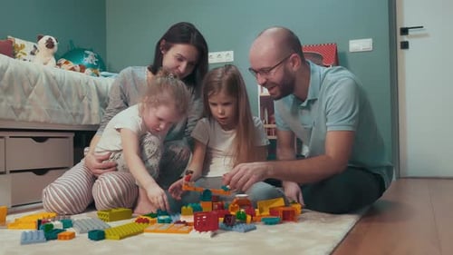 Family Building with Toy Blocks on Carpet at Home