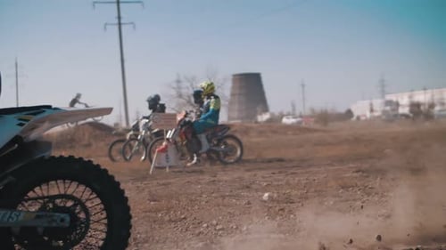 Motocross Motorcyclists Racing on Dirt Track Outdoors